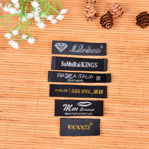 a large number of wholesale clothing accessories washing label customized collar woven green polyester yarn black background with white characters